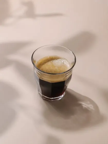 A minimalist shot of an espresso, created for a Bangalore-based coffee brand. This image is clean and modern, focusing on the beautiful crema and shadows.