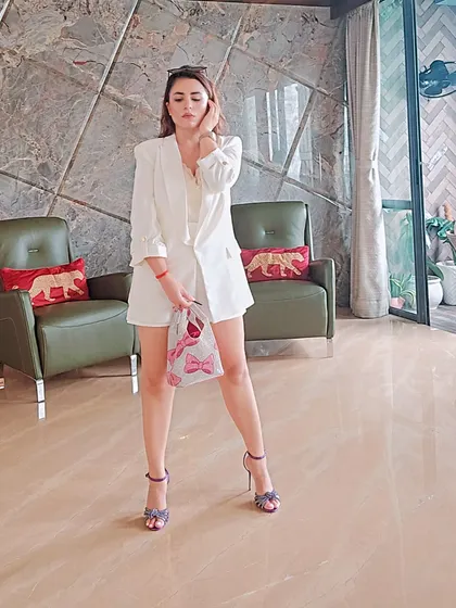 A smart-casual look should feel polished yet easy. This all-white shorts and blazer set is a perfect example. I styled it with a pop of color in the heels and a playful bag to show how accessories can define an outfit.