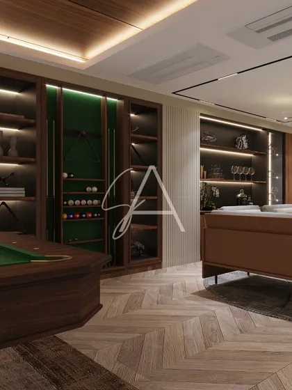 Custom storage is key in a recreation room. This dark wood cabinetry was designed to hold bar essentials and billiard accessories, with integrated lighting to highlight the display.