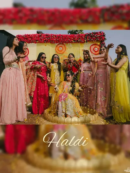 The bride seated on a floral throne, being showered with petals by her bridesmaids. A classic and beautiful Haldi ceremony shot.