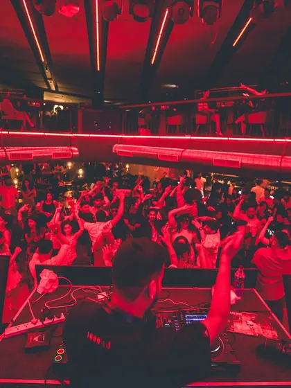 A view from my console as the crowd goes wild under the red lights. This image captures the sheer scale and electric atmosphere I create, turning any corporate gathering into a full-blown party.