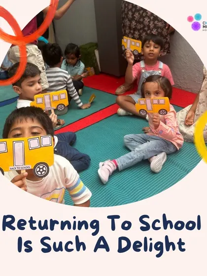Returning to school is such a delight. Children hold up paper buses they made, excited to be back with their friends and teachers.