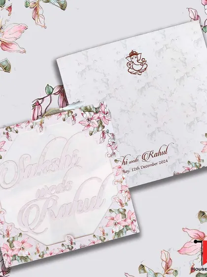 A lightweight custom laser-cut invitation with a pink floral design and names in a beautiful script, offering an elegant look that's easy on the pocket.