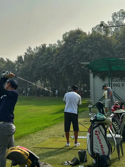 A view of the range from near our fitting studio, with golf bags and players ready for action.