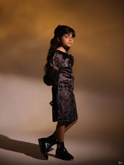 A full-length portrait of Pahal, showcasing her stylish outfit and confident pose. This kind of kids' portfolio shoot is about capturing their unique personality and star quality.