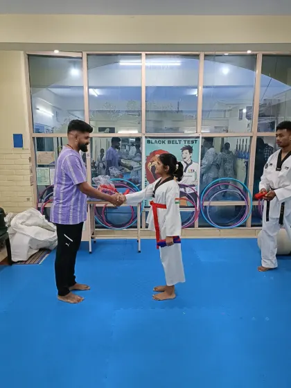 A handshake for a new red belt.