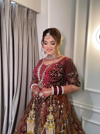 A full-length view of Khushi's bridal attire. My team and I provide complete styling, including expert draping, to ensure your lehenga looks perfect throughout the ceremony.