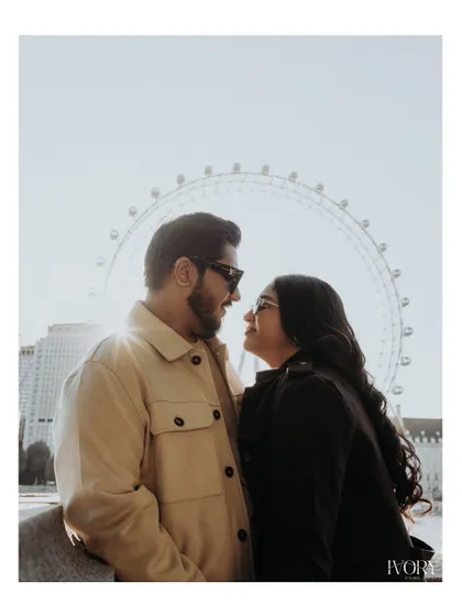 The iconic London Eye provides a perfect silhouette for this intimate couple portrait. The backlighting from the sun creates a beautiful flare, highlighting their connection as they gaze at each other.