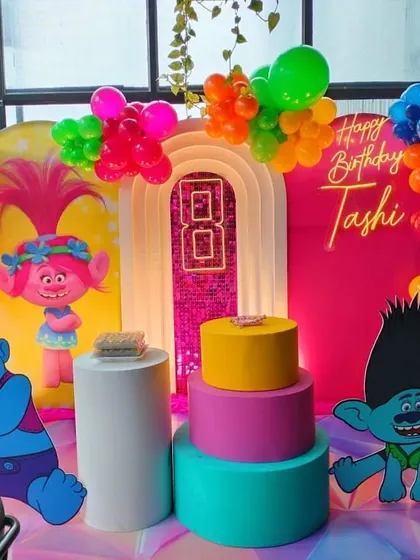 A full view of the Trolls party stage, showing the complete arrangement of props and balloons.