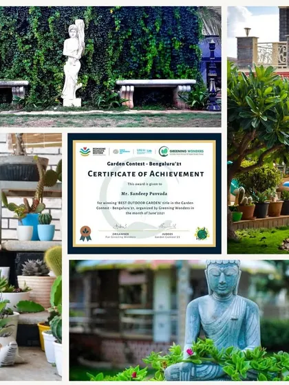 A look at the winning entry for the 'Best Outdoor Garden' category in our 2021 contest. This beautiful garden features classical statues, stone benches, and a lush, well-maintained landscape with a variety of trees and succulents.