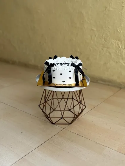 Another angle of the black and white heart-dotted vintage cake.