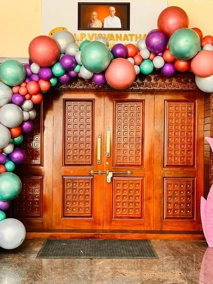A colorful mermaid themed balloon arch over a doorway, setting the stage for an under the sea adventure.