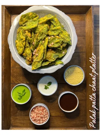 Our Palak Patta Chaat platter features crispy fried spinach leaves served with yogurt, tangy tamarind chutney, and other classic chaat toppings. A perfect crunchy and flavorful treat for Holi.