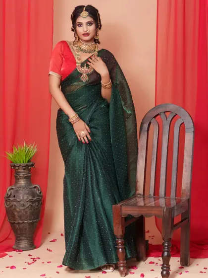 A full-length view of the dark green organza saree, showcasing its graceful drape and rich color. This is a perfect outfit for making a sophisticated statement.