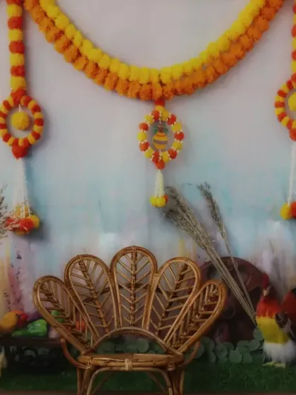 A traditional Indian festival theme, decorated with marigold garlands, painted pots, and a peacock-style wicker chair.
