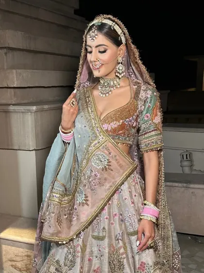A close-up of the Pichwai lehenga, highlighting the detailed artwork and the bride's radiant expression. This is how you blend tradition with personal style.