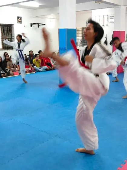 A student executes a powerful high kick.