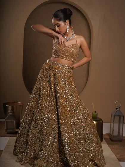 Another angle that captures the elegance of the outfit. The model's pose draws attention to the detailed blouse and the flattering cut of the lehenga, creating a look of pure sophistication.
