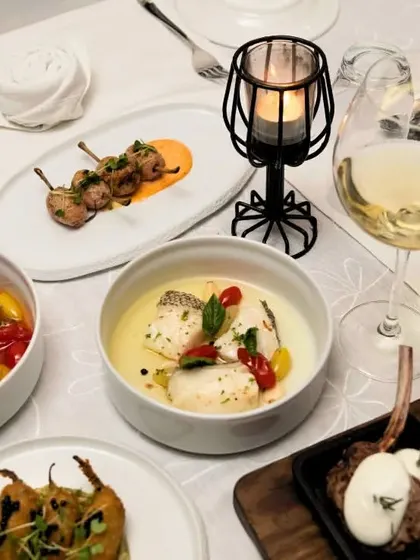 A close-up of a table set for two, with a selection of our most popular dishes ready to be enjoyed by candlelight.