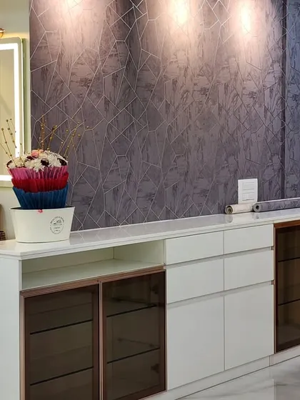 Another angle of the crockery unit, showing its ample storage and the elegant combination of white, wood, and glass.