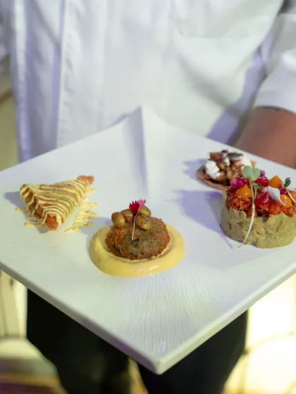 A duplicate of image 21, presenting a curated selection of four different appetizers on a single plate. This demonstrates our ability to offer variety and creativity in our menus.