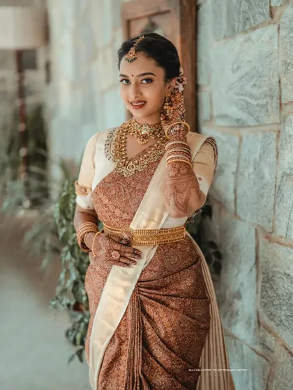 A portrait of timeless South Indian bridal beauty. I focus on capturing the intricate details of the silk saree, the temple jewelry, and the bride's serene expression.