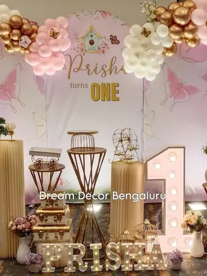 A beautiful 'Butterfly Angel' theme for a first birthday. The decor combines elegant props with pastel balloons for a heavenly look.