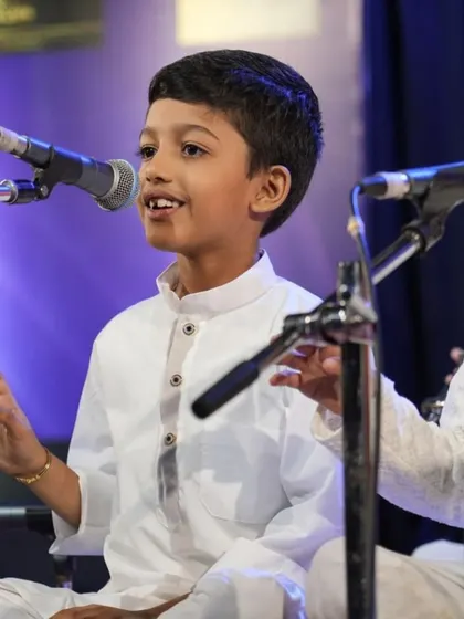 This young vocalist smiles as he sings, embodying the joy we strive to instill in our students.