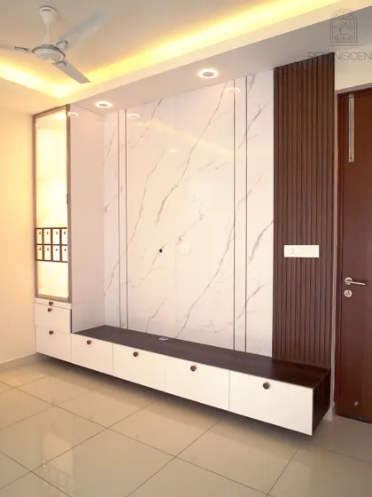 A wider view of the integrated TV and pooja unit, showcasing the clean lines and sophisticated mix of materials. The floating console enhances the sense of space in the room.