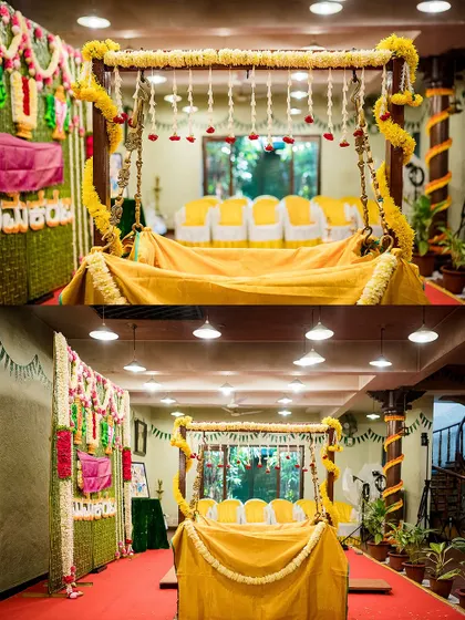 A beautifully decorated swing (jhoola) for a naming ceremony, adorned with yellow flowers and fabrics, ready for the main ritual.