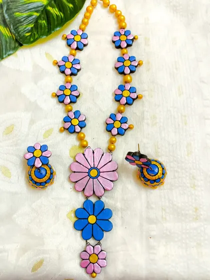 The three-layer floral necklace in a lovely pink and blue combination. This playful color palette is great for spring and summer collections.