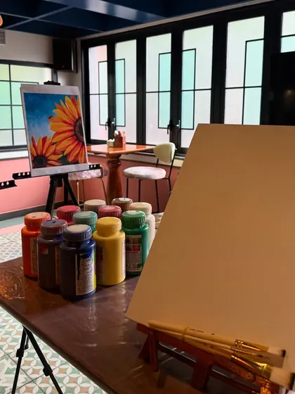 The setup for a sunflower-themed birthday party. We bring everything you need, including pre-sketched canvases, to make your celebration colorful and creative.