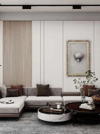 This living room is a perfect example of modern elegance. An L-shaped sectional sofa provides ample seating, while a mix of round coffee tables and a classic armchair adds visual interest. The wall panels and artwork are carefully chosen to complement the neutral and wood-toned palette.