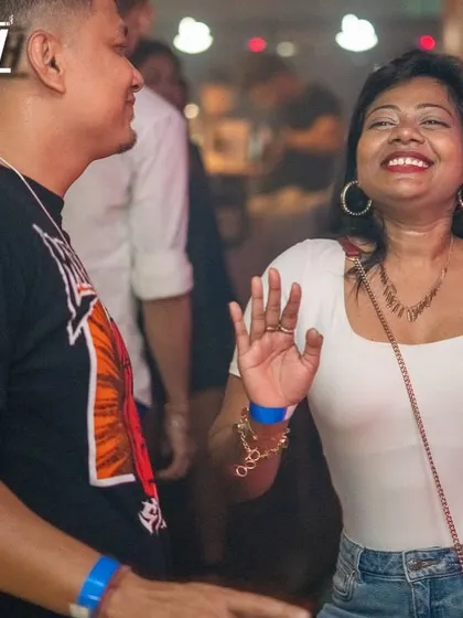 A dancer caught in a moment of pure joy at Babylonia, feeling the rhythm.