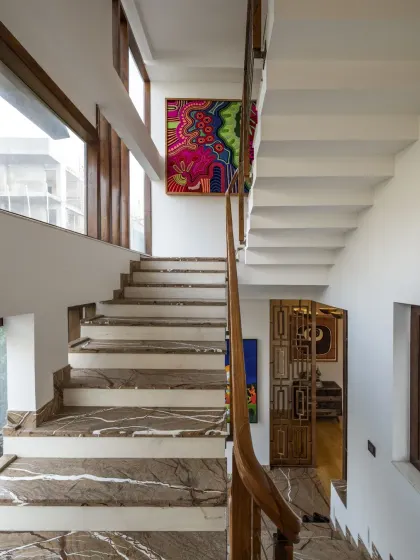 The staircase connecting the various levels of Ashraya Residence is flooded with natural light. Customized artworks greet you at every landing, adding a personal and artistic touch to the vertical journey.