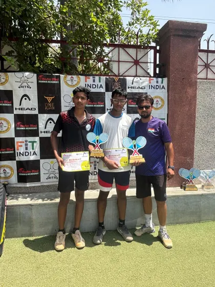 Two of our champions with their coach after a successful AITA tournament. We believe in celebrating every victory, big or small, as a team.