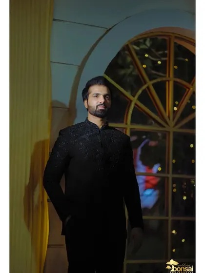 A portrait of the groom in a stylish black bandhgala, perfect for a reception or sangeet night.