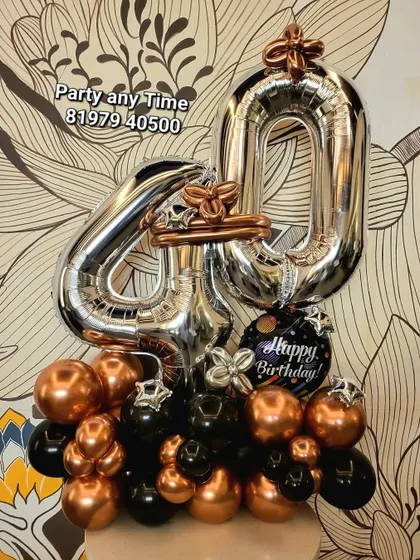 A 40th birthday balloon bouquet in black and rose gold chrome.