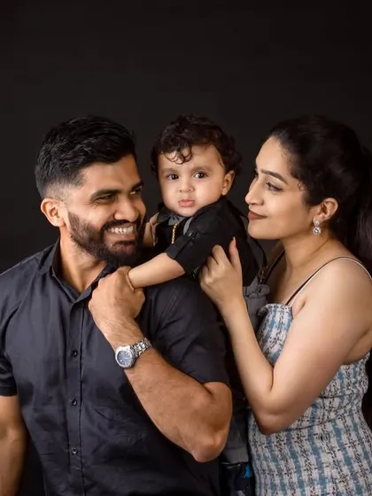 A beautiful family portrait showing the loving interaction between parents and their child. These candid moments are filled with genuine emotion.