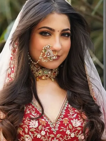 A glimpse of our Rajwadi Bride Collection. This image captures the grace and opulence of a bride adorned in a full set, including a choker and a traditional nath, embodying timeless royal elegance.