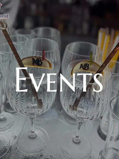 A collection of empty glasses, ready for an event, featuring custom-branded stirrers. We ensure every element of the bar service, down to the smallest detail, reflects your personal style.