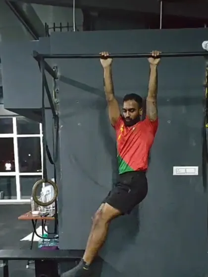 A member working on his pull-up form. Consistency with foundational exercises like this is key to building the strength for more advanced skills.