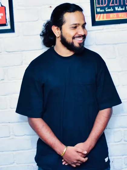 A relaxed portrait against a white brick wall. This shot reflects my easygoing personality when I'm not behind the decks.