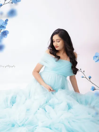 A duplicate of image 122, this dreamy portrait in a cloud of blue tulle is serene and ethereal.