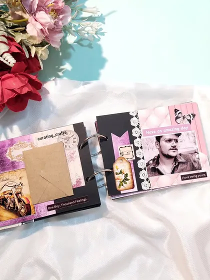 A page with an envelope for a secret note and a vintage motorcycle sticker.