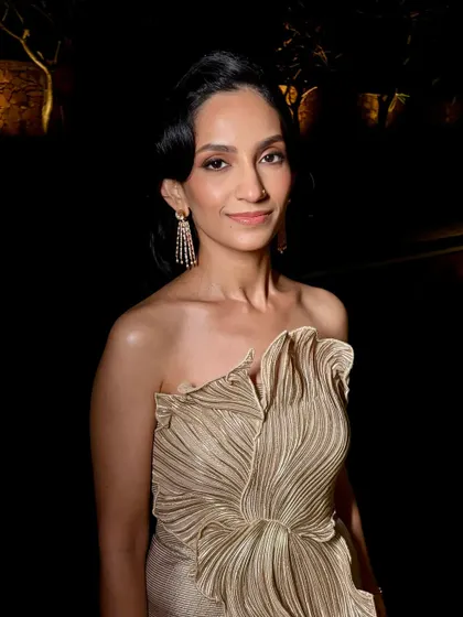 A portrait in the evening light. The makeup is subtle yet impactful, perfect for a chic cocktail party.