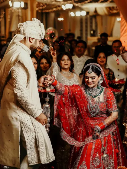 A candid and playful moment during the wedding rituals, capturing the bride's happy expression.