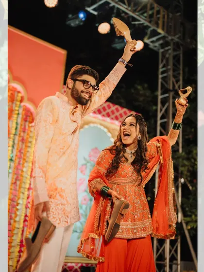 The fun and games that make a wedding personal. Here, the couple proudly shows off the groom's shoes after a successful 'joota chupai' during the Haldi festivities.