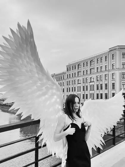 Another artistic shot from the angel wings series. We love the contrast of the delicate wings and the strong city architecture.