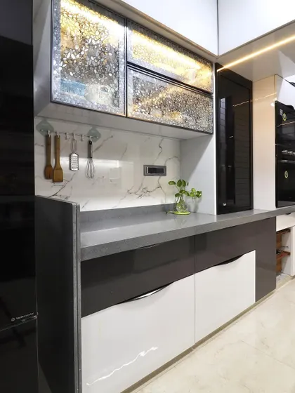 This shot showcases a dedicated section of the kitchen with unique, textured metallic-finish cabinets. This custom feature adds a touch of luxury and serves as a focal point in the design.